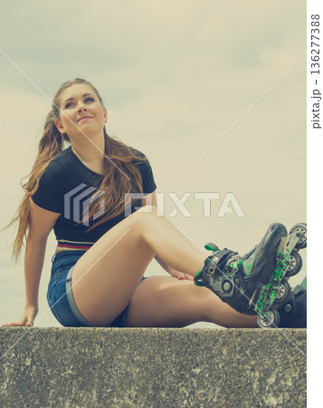 Fit girl with roller skates outdoor Fit girl with roller skates outdoor 136277388