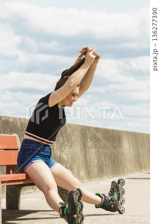 Joyful girl wearing roller skates Joyful girl wearing roller skates 136277390