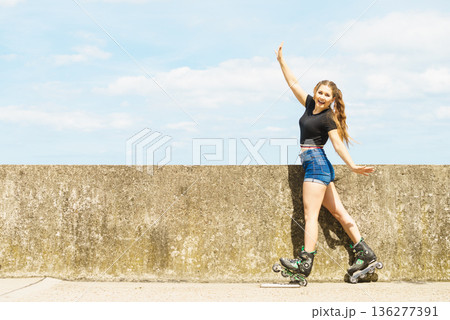 Fit girl with roller skates outdoor Fit girl with roller skates outdoor 136277391