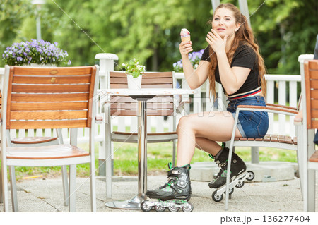 Roller skate woman eating ice cream 136277404