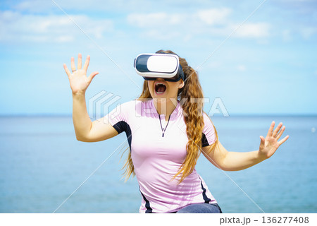 Woman wearing VR outside 136277408