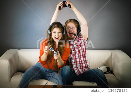 Gamer couple playing games Gamer couple playing games 136278122