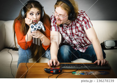 Pc gamer man and woman with game pad Pc gamer man and woman with game pad 136278139