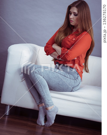 Angry woman sitting on sofa 136278170
