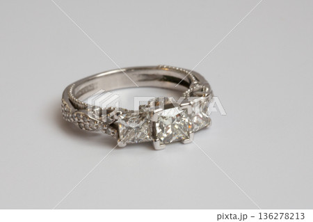Engagement diamond wedding ring group on white. A white gold ring with large natural princess-cut or Square Modified Brilliant diamonds. Engagement diamond wedding ring group on white. A white gold ring with large natural princess-cut or Square Modified Brilliant diamonds. 136278213
