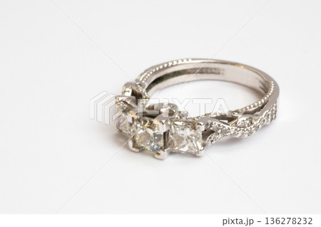 Engagement diamond wedding ring group on white. A white gold ring with large natural princess-cut or Square Modified Brilliant diamonds. 136278232