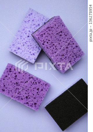 Violet dishwashing sponges on violet background. Household cleaning sponge. Vertical photo Violet dishwashing sponges on violet background. Household cleaning sponge. Vertical photo 136278954