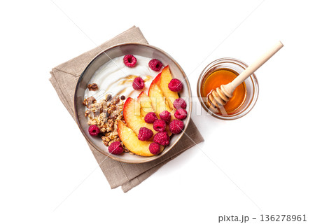 Granola bowl with greek yogurt, peach, raspberry and honey isolated Granola bowl with greek yogurt, peach, raspberry and honey isolated 136278961