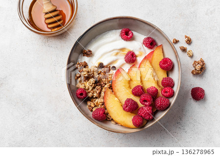 Granola bowl with greek yogurt, peach, raspberry and honey Granola bowl with greek yogurt, peach, raspberry and honey 136278965