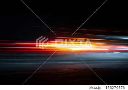 A blurry, fast-moving light, reminiscent of headlight trails on a city road, with a very long exposure and night lighting. The speed effect 136279576