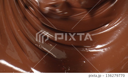 Melting chocolate in a bowl during baking session in a warm kitchen at afternoon Melting chocolate in a bowl during baking session in a warm kitchen at afternoon 136279770