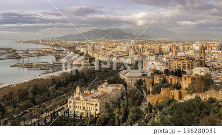 Coastal Cityscape Of Malaga With Historical buildings, Modern Waterfront And Mountain Backdrop At sunrise Coastal Cityscape Of Malaga With Historical buildings, Modern Waterfront And Mountain Backdrop At sunrise 136280031