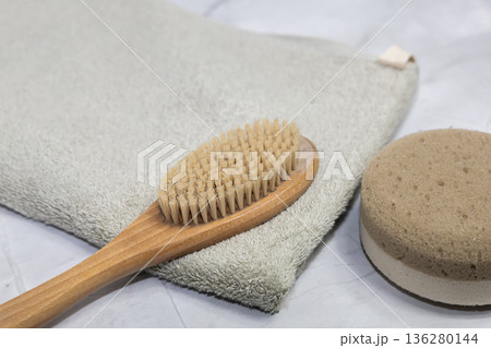 Natural bath accessories on light green towel. Natural bath accessories on light green towel. 136280144