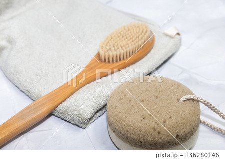 Natural bath accessories on light green towel. 136280146