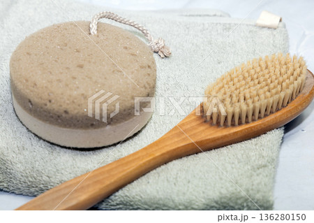 Natural bath accessories on light green towel. Natural bath accessories on light green towel. 136280150