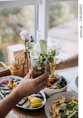 Brunch toast with fresh mint cocktails and healthy food by window, cozy restaurant vibe, copy space Brunch toast with fresh mint cocktails and healthy food by window, cozy restaurant vibe, copy space 136280802
