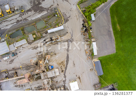 View of construction site with machinery vehicles surrounded by stone quarry water area 136281377