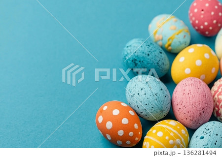 Easter eggs on a bright blue background. Easter celebration concept. Colorful easter handmade decorated Easter eggs. Place for text. Copy space. Easter eggs on a bright blue background. Easter celebration concept. Colorful easter handmade decorated Easter eggs. Place for text. Copy space. 136281494