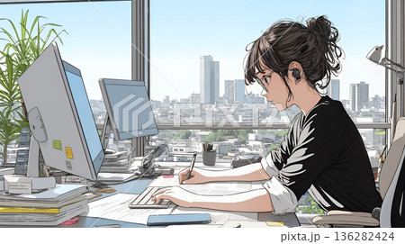 職場のデスクでパソコンに向かって仕事をしているビジネスウーマン