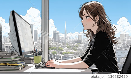 職場のデスクでパソコンに向かって仕事をしているビジネスウーマン