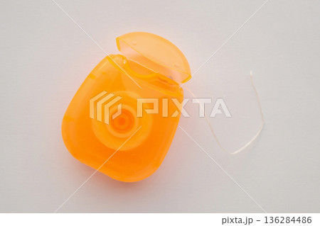 dental floss in case on white background 136284486