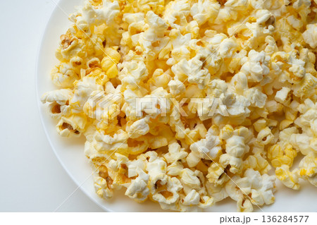 Tasty popcorn close up background top view Tasty popcorn close up background top view 136284577