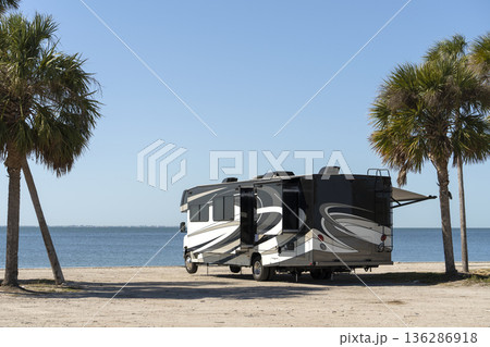 Road trip in Florida. Camper motor home on ocean beach shore. USA travel transportation infrastructure. Road trip in Florida. Camper motor home on ocean beach shore. USA travel transportation infrastructure. 136286918