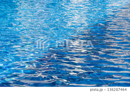 Blue Swimming Pool Water Surface with Sunlight Reflections Blue Swimming Pool Water Surface with Sunlight Reflections 136287464