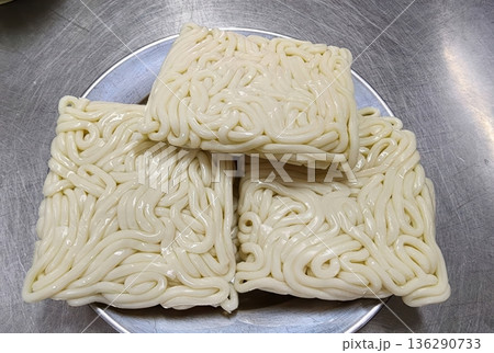 Frozen Japanese Udon Noodles Blocks on Stainless Steel Plate 136290733