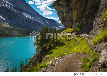 Stunning hiking trail on the shore of the Oeschinensee Lake 136291176