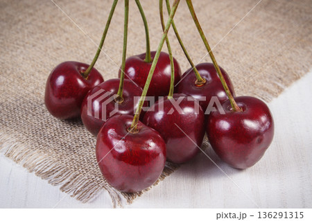 Fresh ripe cherries on jute cloth. Healthy dessert or snack Fresh ripe cherries on jute cloth. Healthy dessert or snack 136291315