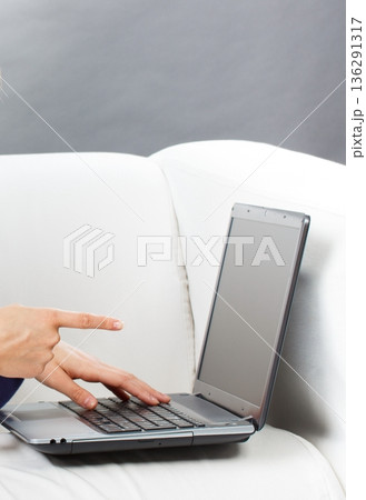 Hands of woman with laptop. Relaxing or working with computer Hands of woman with laptop. Relaxing or working with computer 136291317