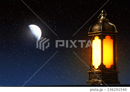 Glowing Ramadan Lantern and Crescent Moon in Starry Night Sky. Islamic Greeting Background for Eid Mubarak and Kareem. High quality photo Glowing Ramadan Lantern and Crescent Moon in Starry Night Sky. Islamic Greeting Background for Eid Mubarak and Kareem. High quality photo 136291540