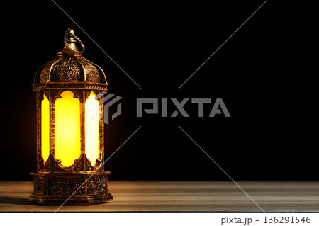 Golden Arabic Lantern with Warm Glow on Wooden Table Against Black Background. Ramadan and Eid Mubarak Concept. High quality photo 136291546