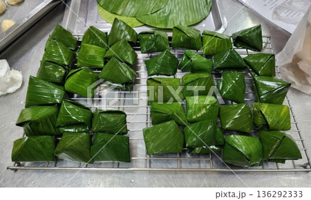 Traditional Thai Steamed Flour Desserts Wrapped in Banana Leaves Traditional Thai Steamed Flour Desserts Wrapped in Banana Leaves 136292333