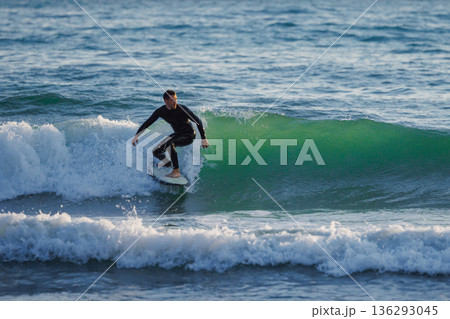 Surfer ride a clean green wave, aquatic water sport in the ocean. Surfer ride a clean green wave, aquatic water sport in the ocean. 136293045