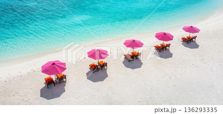 Relaxing aerial beach scenic pink umbrellas luxury resort getaway landscape ocean bay sandy shore tropical island summer vacation wallpaper background 136293335