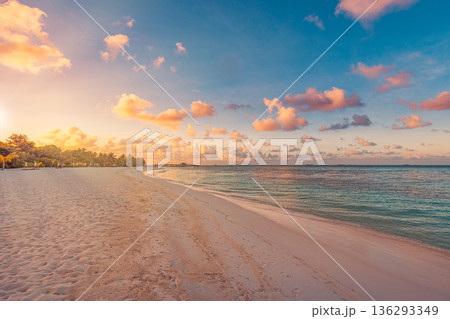 Amazing Maldives sunset beach landscape. Tropical ocean view and sandy shore summer scenery Amazing Maldives sunset beach landscape. Tropical ocean view and sandy shore summer scenery 136293349