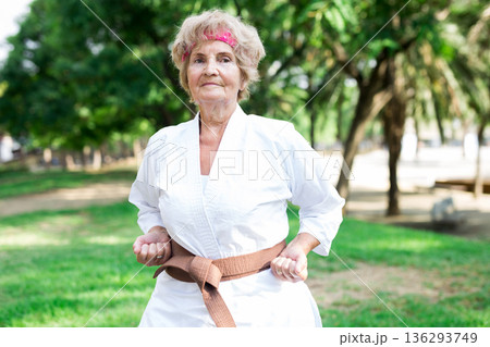 Old woman in kimono training in park Old woman in kimono training in park 136293749