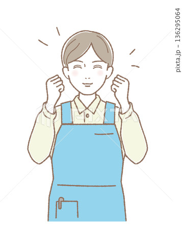 エプロン姿で笑顔のガッツポーズをする男性 介護・福祉スタッフ 136295064