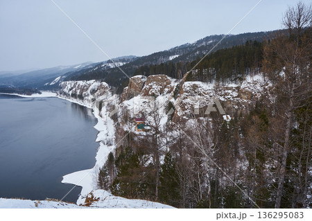 Yenisei river flowing next to snow covered cliffs at Karaulnenskoye Highlands near Krasnoyarsk, Russia. Winter landscape of Siberian nature. 136295083