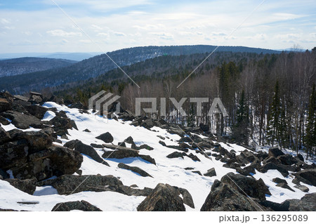 Snow covered slope of mountain with boulders. Beautiful winter forest panorama. Rocky landscape with pine trees for nature travel content. Snow covered slope of mountain with boulders. Beautiful winter forest panorama. Rocky landscape with pine trees for nature travel content. 136295089