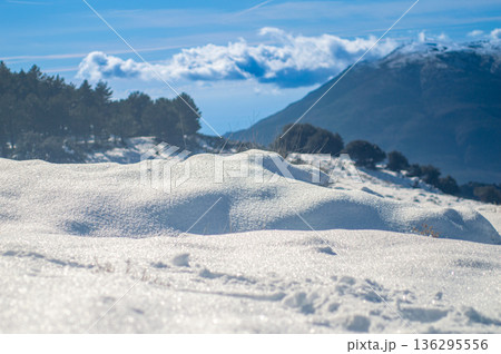Pristine winter mountain views reveal snow-covered peaks and untouched alpine landscapes in the Sierra Nevada, Spain. Pristine winter mountain views reveal snow-covered peaks and untouched alpine landscapes in the Sierra Nevada, Spain. 136295556