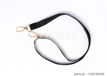 Black Fabric Lanyard Strap with Gold Metal Swivel Snap Hooks on White Background Flat Lay Black Fabric Lanyard Strap with Gold Metal Swivel Snap Hooks on White Background Flat Lay 136296080