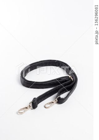 Top view of black nylon bag strap with two gold-tone carabiners Top view of black nylon bag strap with two gold-tone carabiners 136296081