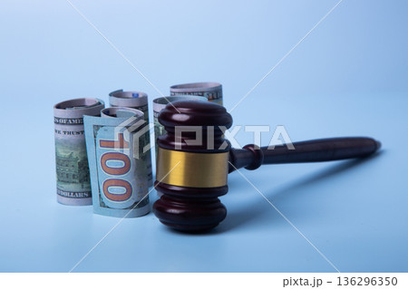 Gavel and rolled cash representing corruption and bribery law Gavel and rolled cash representing corruption and bribery law 136296350