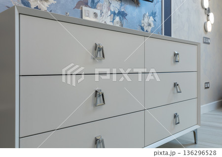 Modern White Dresser with Chrome Hardware in Bedroom Modern White Dresser with Chrome Hardware in Bedroom 136296528
