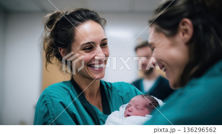 Midwife hands newborn baby to happy parent 136296562