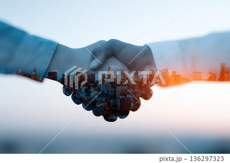 Business handshake superimposed over city 136297323