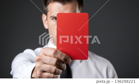 Man shows bright red card with stern expression - ai generated 136298221